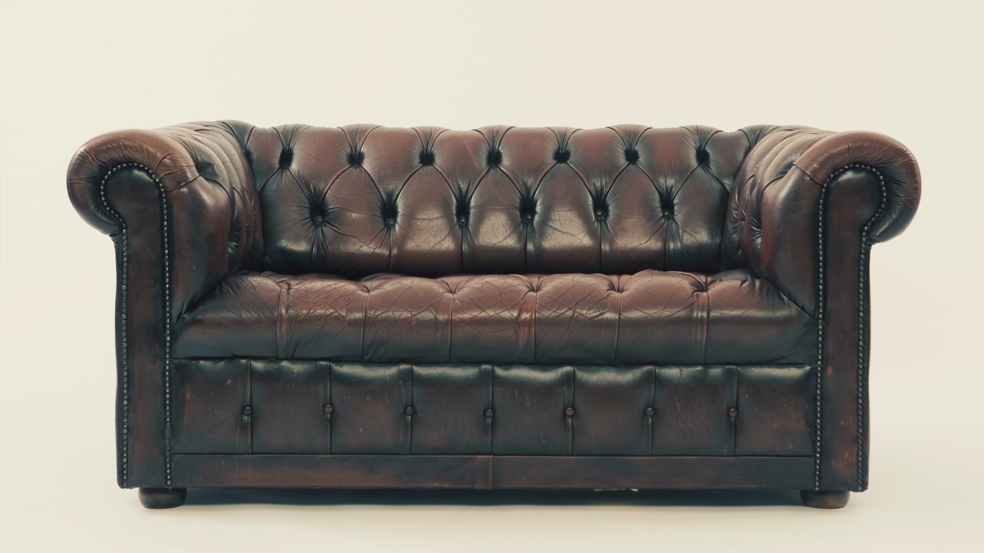brown leather Chesterfield sofa